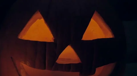 Glowing Candle Illuminates a Spooky Jack o'lantern Pumpkin Stock Footage 68930833