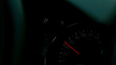 Glowing car instrument panel with pointers at night Stock Footage