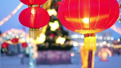 Glowing Chinese red lanterns hang against a soft evening sky Video stock 328694887