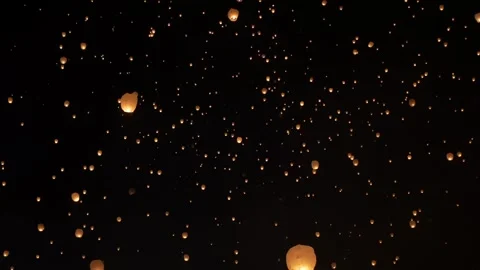 Glowing Chinese Sky Lanterns Ascending at Night Stock Footage 339268178