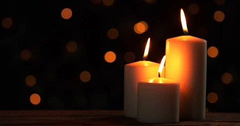 Glowing Christmas candles on the wooden table Stock Footage