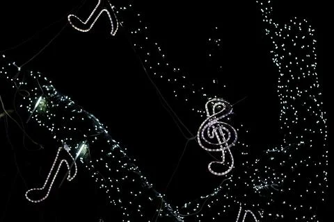 Glowing Christmas decorations in the form of notes and a treble clef. 写真素材