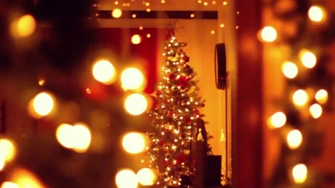 Glowing Christmas tree with warm lights and festive reflections indoors Stock Footage 222033757