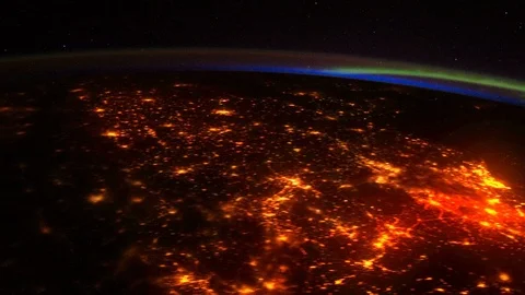 Glowing cities on the night side of Earth as seen from space. Stock Footage 98791622