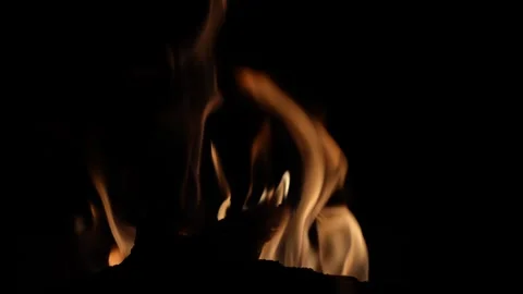 Glowing coals erupt in a dazzling display, casting a captivating play of light Stock Footage 289894100