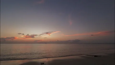 Glowing colorful sky and dramatic clouds over sea after sunset, time lapse. Stock Footage 332100073