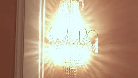 Glowing crystal sconce hanging on wall. Crystal chandelier Stock Footage