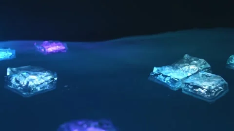 Glowing decorative cubes float on the water in the dark, changing colors. Neon Stock Footage 303893310