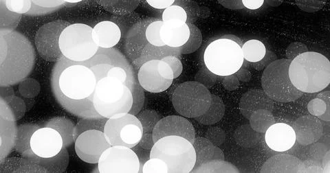 Glowing defocused circular light spots creating layered bokeh pattern on dark Illustrazione stock