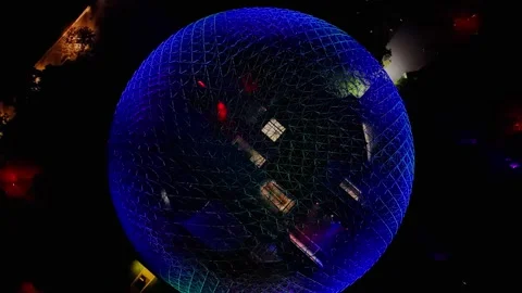 Glowing disco ball reflects vibrant, shifting colors Stock Footage 345622586