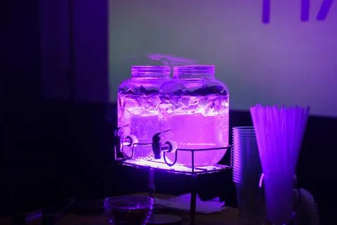 Glowing drinks on display during an evening event at a venue Stock Photos