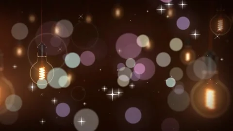 Glowing edison light bulbs hanging amidst floating bokeh particles and Stockbeeldmateriaal 344290722