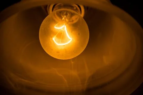Glowing element of an incandescent bulb Stock Photos
