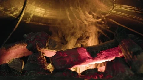 The Glowing Embers and Dancing Flames create a Warm and Inviting Fireplace Video stock 314710308