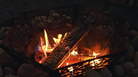 Glowing Embers Dance Within a Rustic Stone Fire Pit at Midnight in Nature Stock Footage 346048868