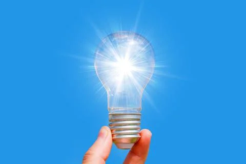 Glowing Empty Light Bulb in Hand Isolated on Blue 스톡 사진
