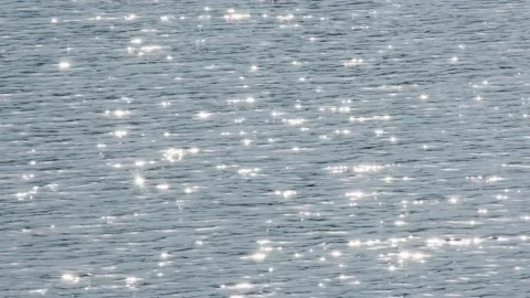 Glowing endless calm water surface ripple smooth pond sea river ocean. Bright Stock Footage 167334863