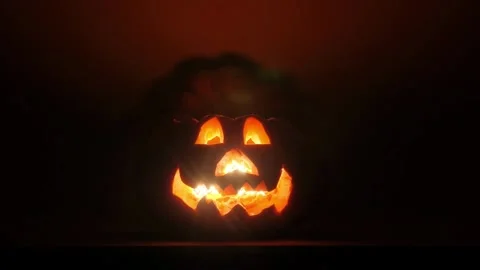 Glowing face on a pumpkin, preparing for the celebration of Stock Footage 272458912