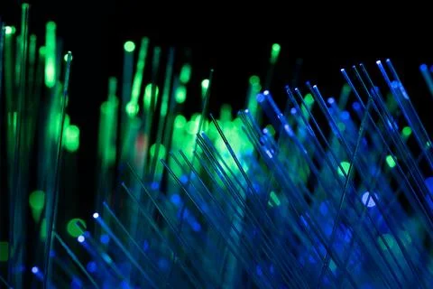 Glowing Fiber Optic Network Background in Blue and Green Colors Foto stock