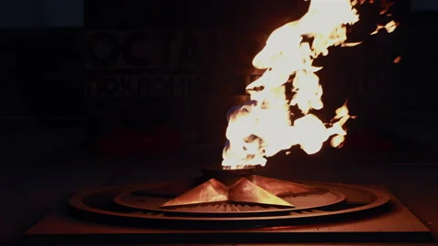Glowing fire of eternal flame burning from bronze star monument Vidéo 331006968