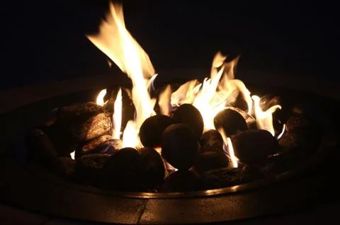 Glowing fire pit in the evening Stock Photos