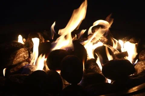 Glowing fire pit in the evening Stock Photos