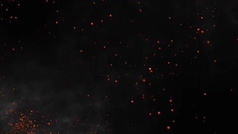 Glowing fire sparks and burning embers flying in a dark smoke background. Stock-Footage 339802915