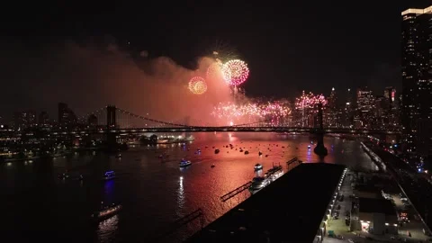 Glowing fireworks explosion in front of skyline in New York City, USA at night Stock Footage 312976615