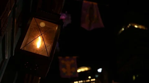 Glowing Flickering Lantern outside store window in urban downtown city at night Video stock 83016345