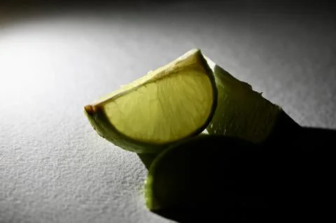 Glowing Fresh Lime Slice in Dramatic Spotlight Macro Close-Up Photos