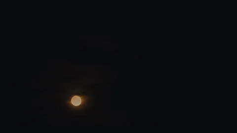 A glowing full moon partially veiled by clouds. Stock Footage 299897247
