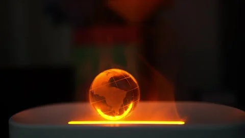 Glowing Globe with South America Map and Smoke, A glowing orange globe with.. 库存影片 304876072