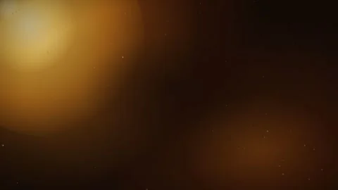 A glowing, golden amber orb of light creates a soft bokeh effect against a .. Stock Footage 346103359