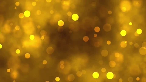 Glowing golden bokeh particles floating smoothly on a abstract background 库存影片 343485202