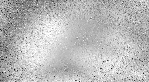 Glowing gradient gray background with contrasting water drops Stock-Fotos