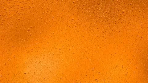 Glowing gradient orange background with contrasting water drops Stock Photos