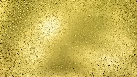 Glowing gradient yellow background with contrasting water drops Stock Photos