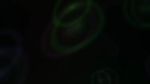 Glowing green circles on black background. Stock Footage 335954314