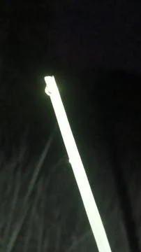 Glowing Green Light Beam in Dark Night Landscape Stock-Fotos