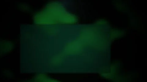 Glowing green rectangle on dark background with blurry shapes. Stock Footage 336234753