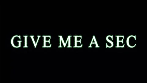 Glowing green text saying Give Me A Sec repeats across a dark background wi.. Stock Footage 344035493