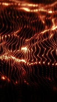 Glowing grid of orange particles forming fluid wave patterns in a dark digita Stock Photos