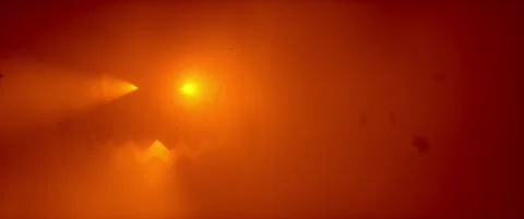 Glowing Halloween jack-o-lantern face in orange red fog with falling autumn leav Stock Footage 345551158
