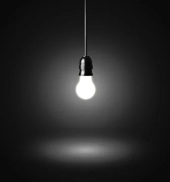 Glowing hanging light bulb on a wire Photos