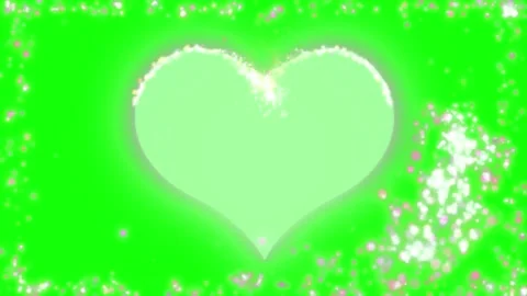Glowing heart shape surrounded by shimmering particle dust on green screen Stock Footage 338388614