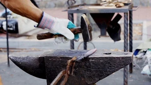Glowing hot blade getting struck by a heavy hammer Stock Footage 112210453