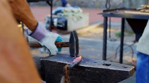 Glowing hot blade getting struck by a heavy hammer Stock Footage 112210559