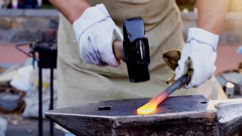 Glowing hot blade getting struck by a heavy hammer Stock Footage 112210650