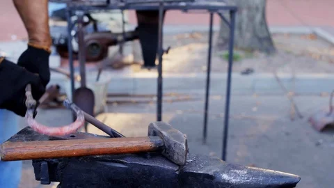 Glowing hot blade getting struck by a heavy hammer Stock Footage 112210680
