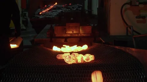 Glowing Hot Steel Parts at Forging Facility, Wide slider shot of Conveyor Belt Stock Footage